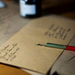 Close-up of vintage letters with a pen and ink, showcasing classic handwriting.